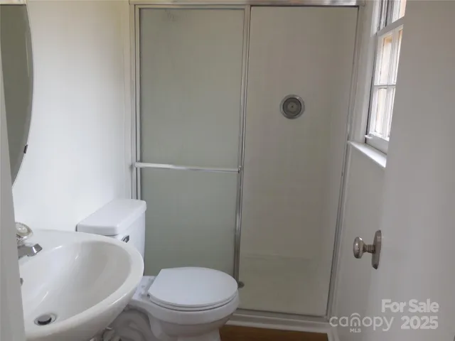 a white toilet sitting next to a bathroom sink