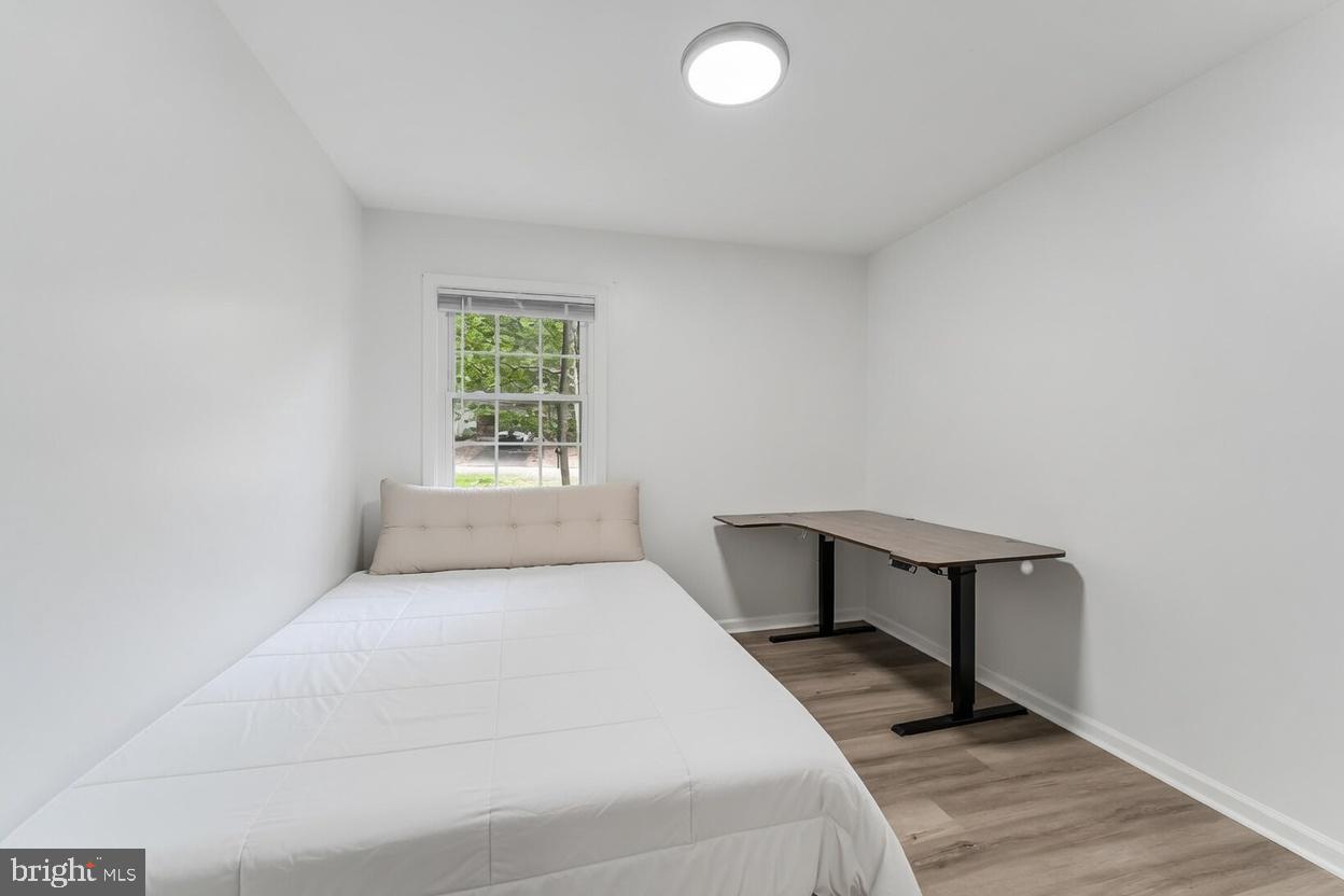 11621 Sourwood Lane Reston, VA 20191 - Photo 22 of 26 a bedroom with a bed and a window