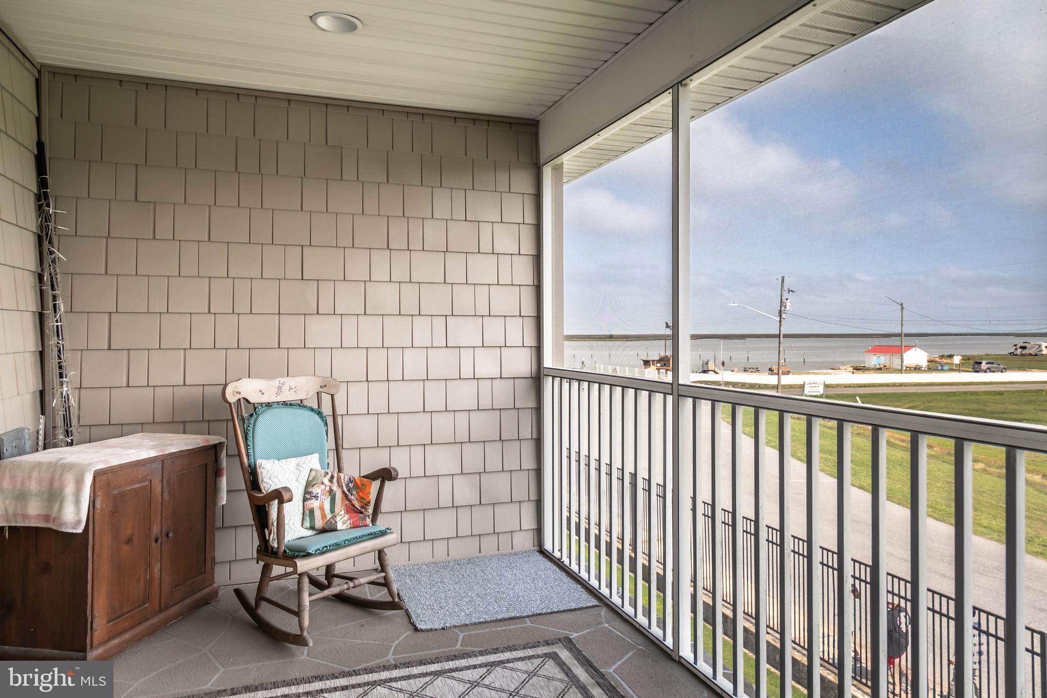 111 Sunset Circle, Unit 111E Crisfield, MD 21817 - Photo 12 of 57 a view of a chair in a balcony