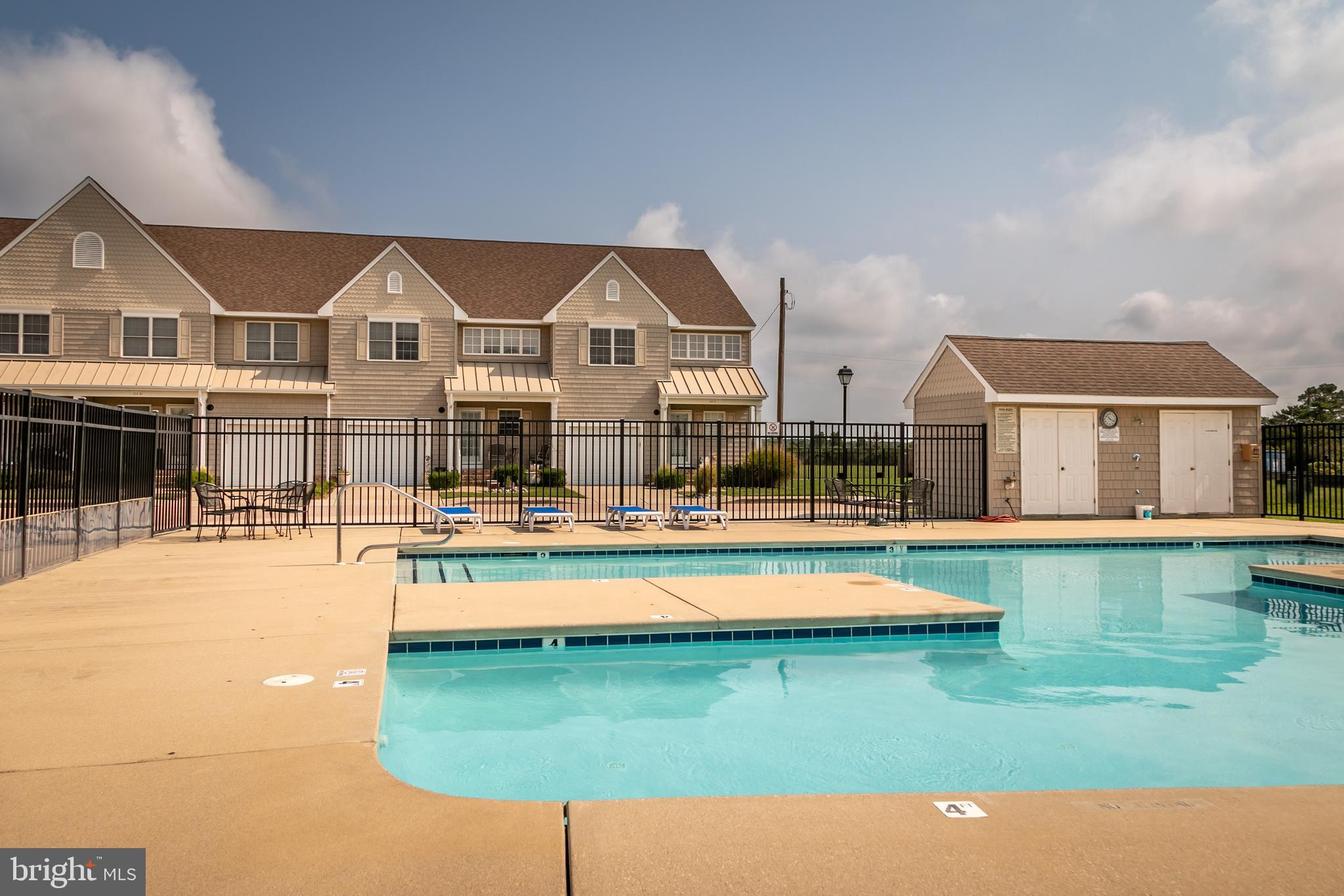 111 Sunset Circle, Unit 111E Crisfield, MD 21817 - Photo 17 of 57 a swimming pool with outdoor seating and yard