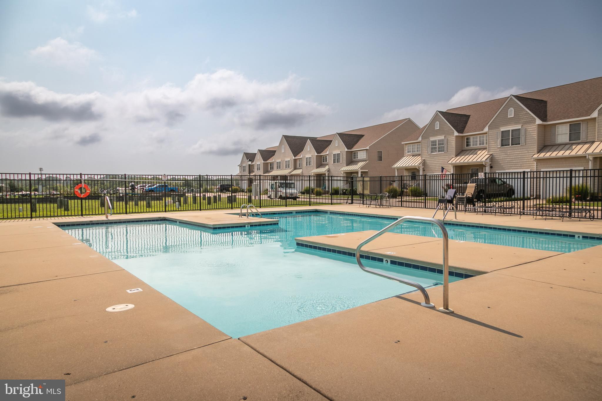 111 Sunset Circle, Unit 111E Crisfield, MD 21817 - Photo 18 of 57 a view of a swimming pool and an outdoor seating