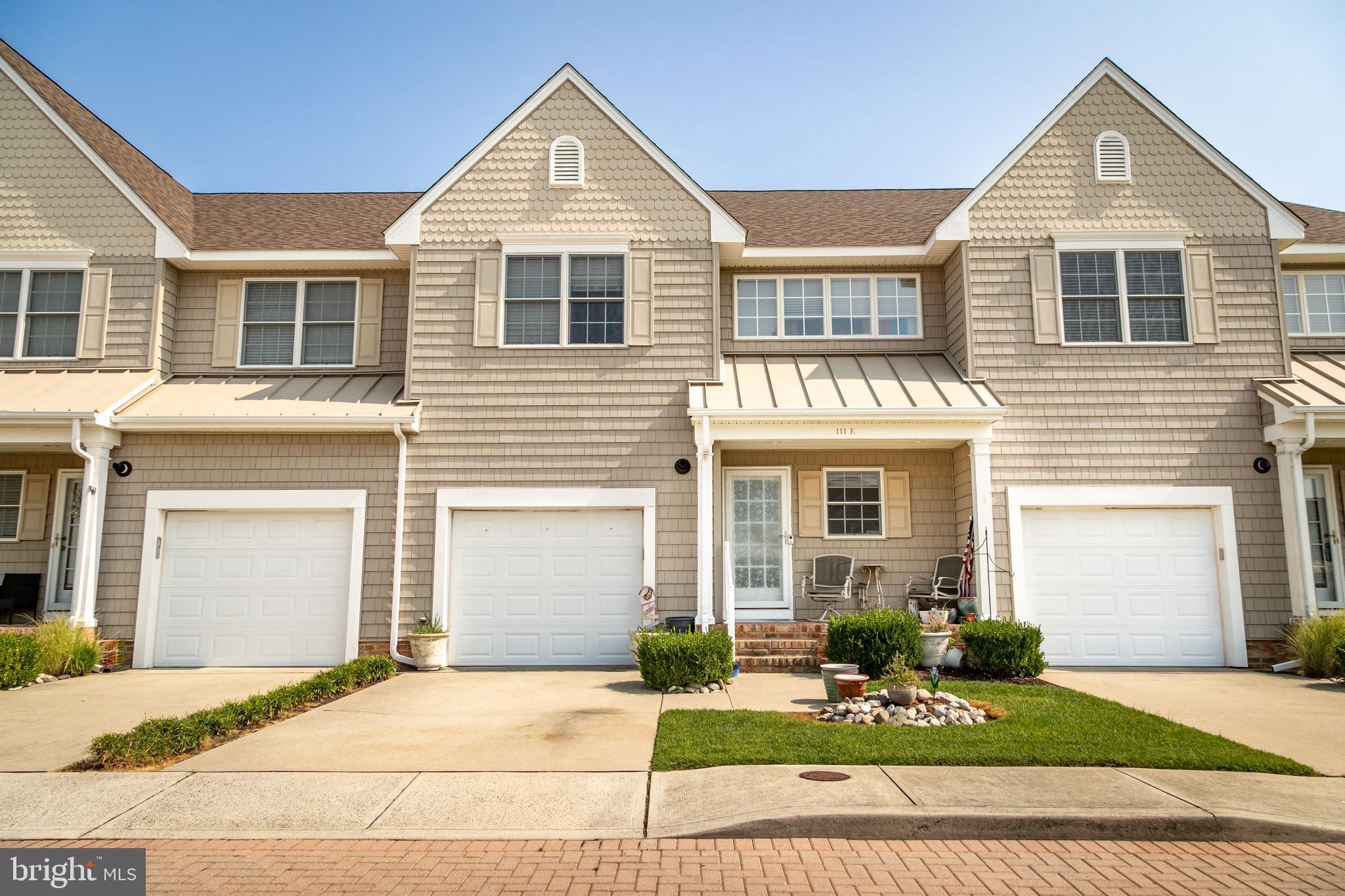 111 Sunset Circle, Unit 111E Crisfield, MD 21817 - Photo 2 of 57 a front view of a house with garden