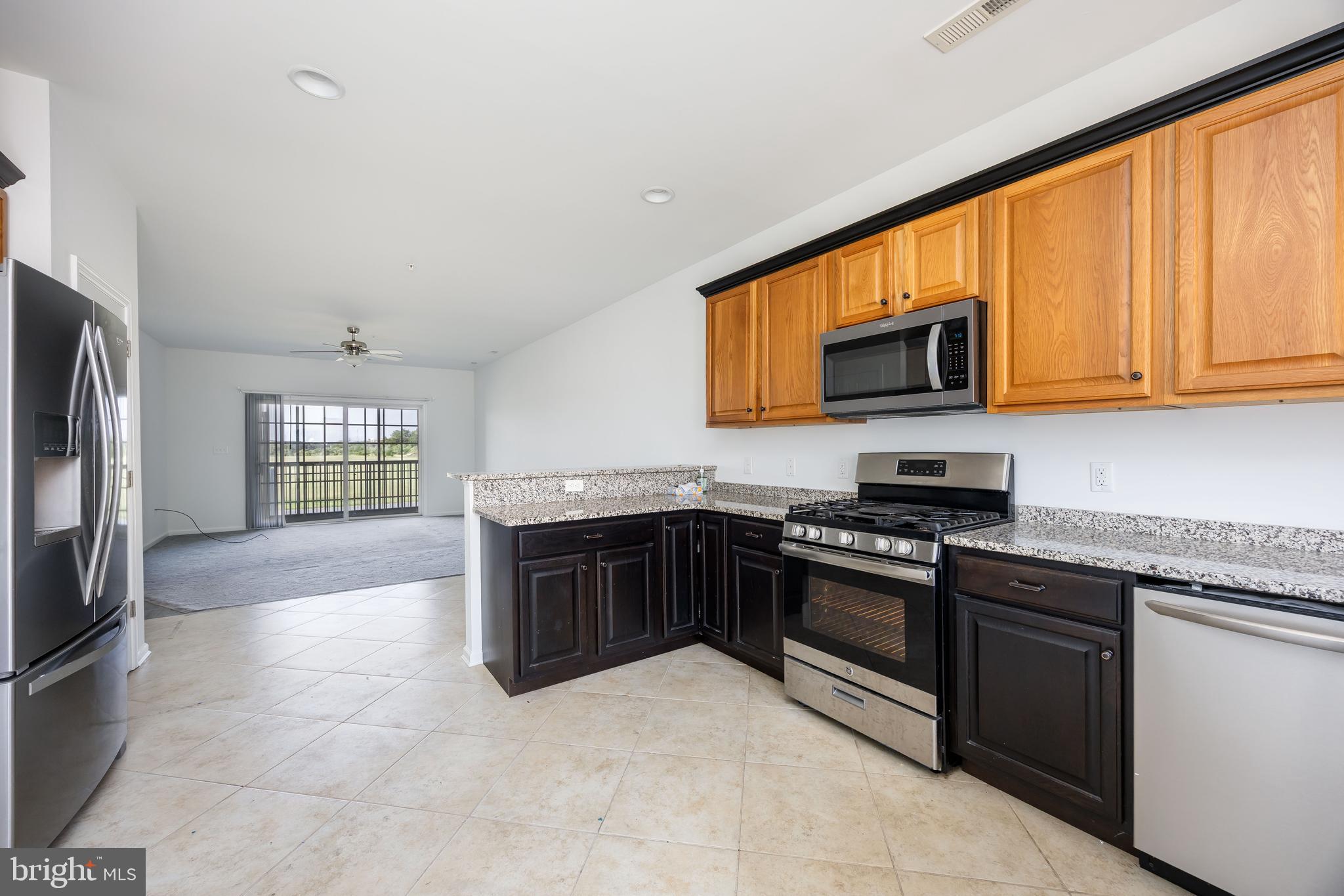 111 Sunset Circle, Unit 111E Crisfield, MD 21817 - Photo 21 of 57 a kitchen with stainless steel appliances granite countertop a stove top oven a sink dishwasher and a refrigerator