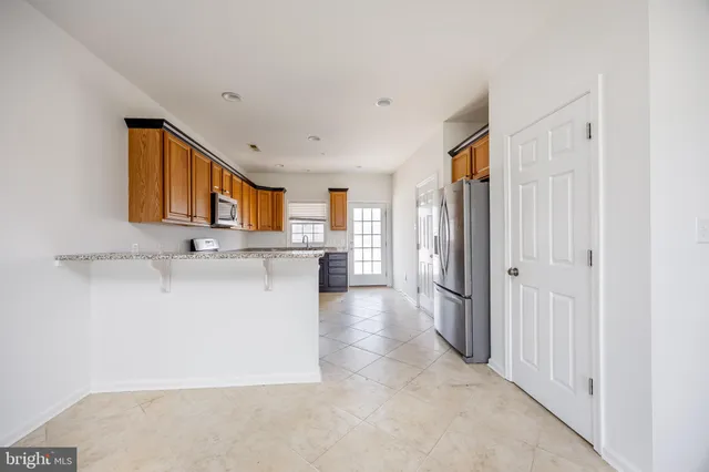 a view of a hallway with wooden floor and entryway