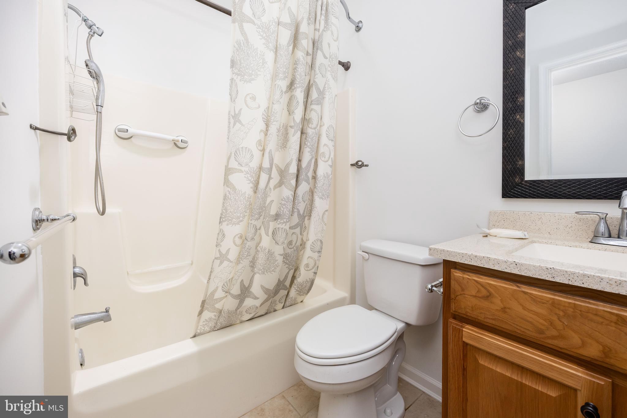 111 Sunset Circle, Unit 111E Crisfield, MD 21817 - Photo 30 of 57 a bathroom with a sink toilet and shower