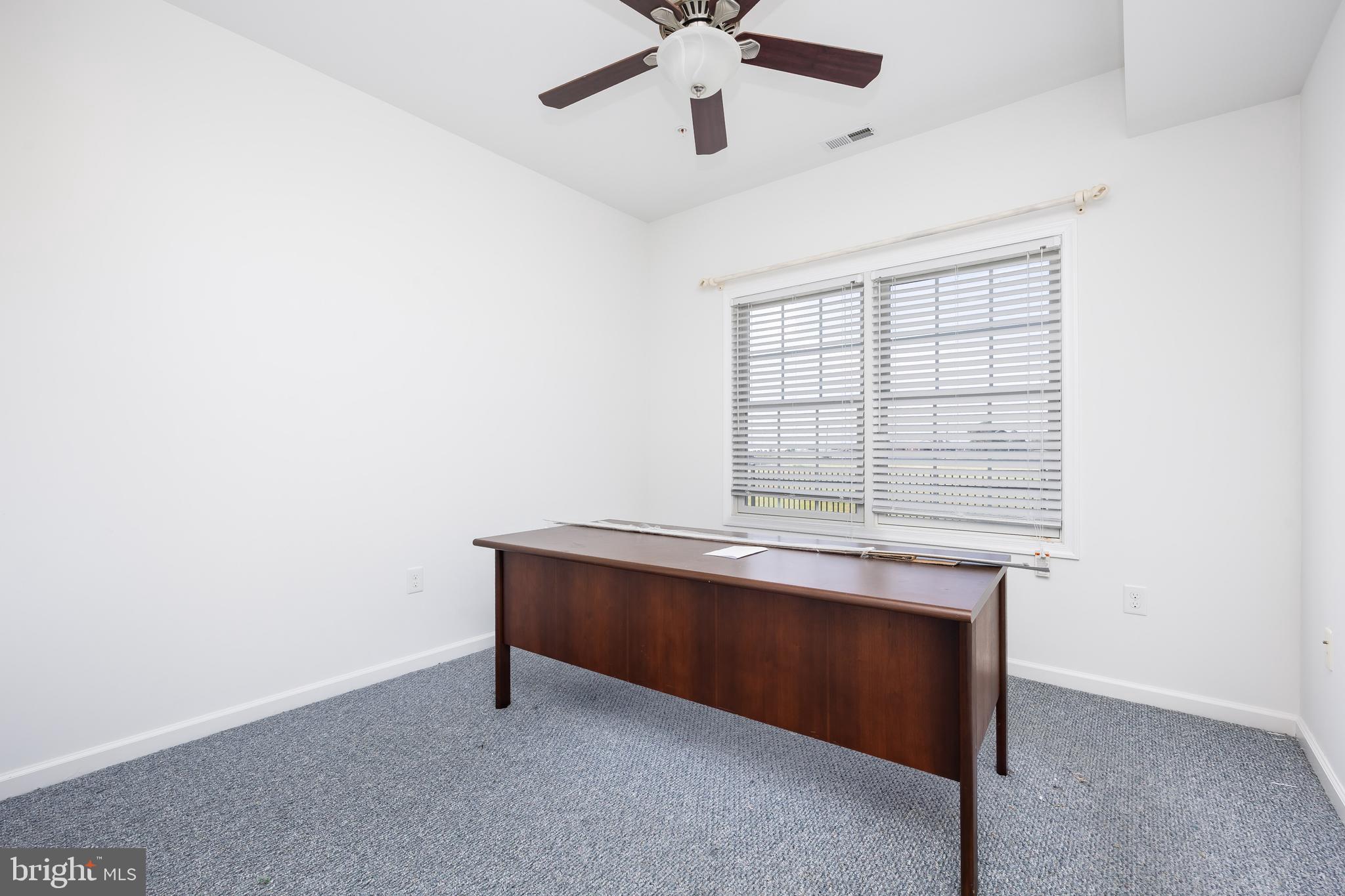 111 Sunset Circle, Unit 111E Crisfield, MD 21817 - Photo 32 of 57 a room with chandelier and window