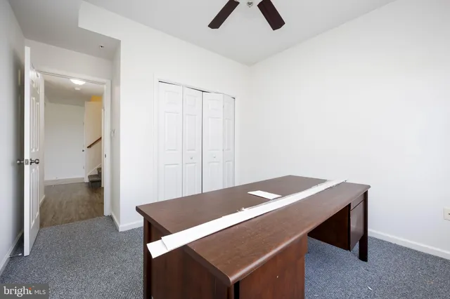 a bathroom with a granite countertop sink a toilet and shower