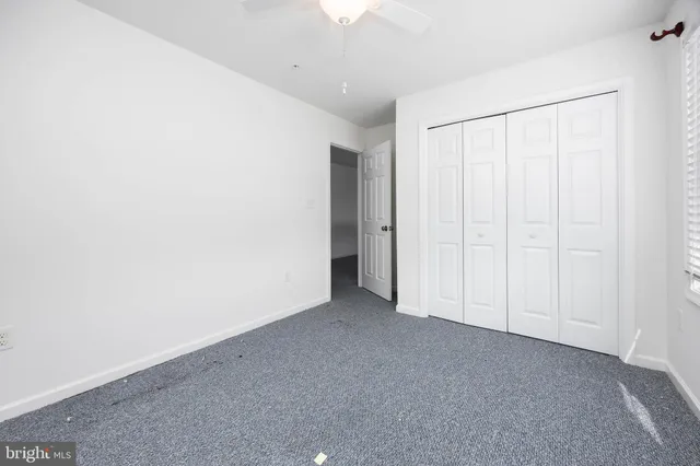 a view of a livingroom with a ceiling fan and window