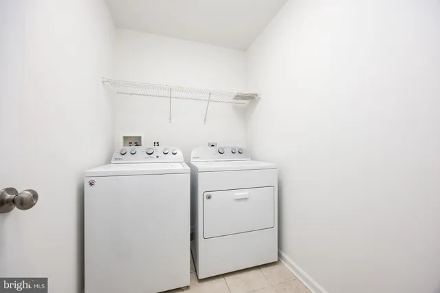a bathroom with a granite countertop double vanity sink mirror and toilet