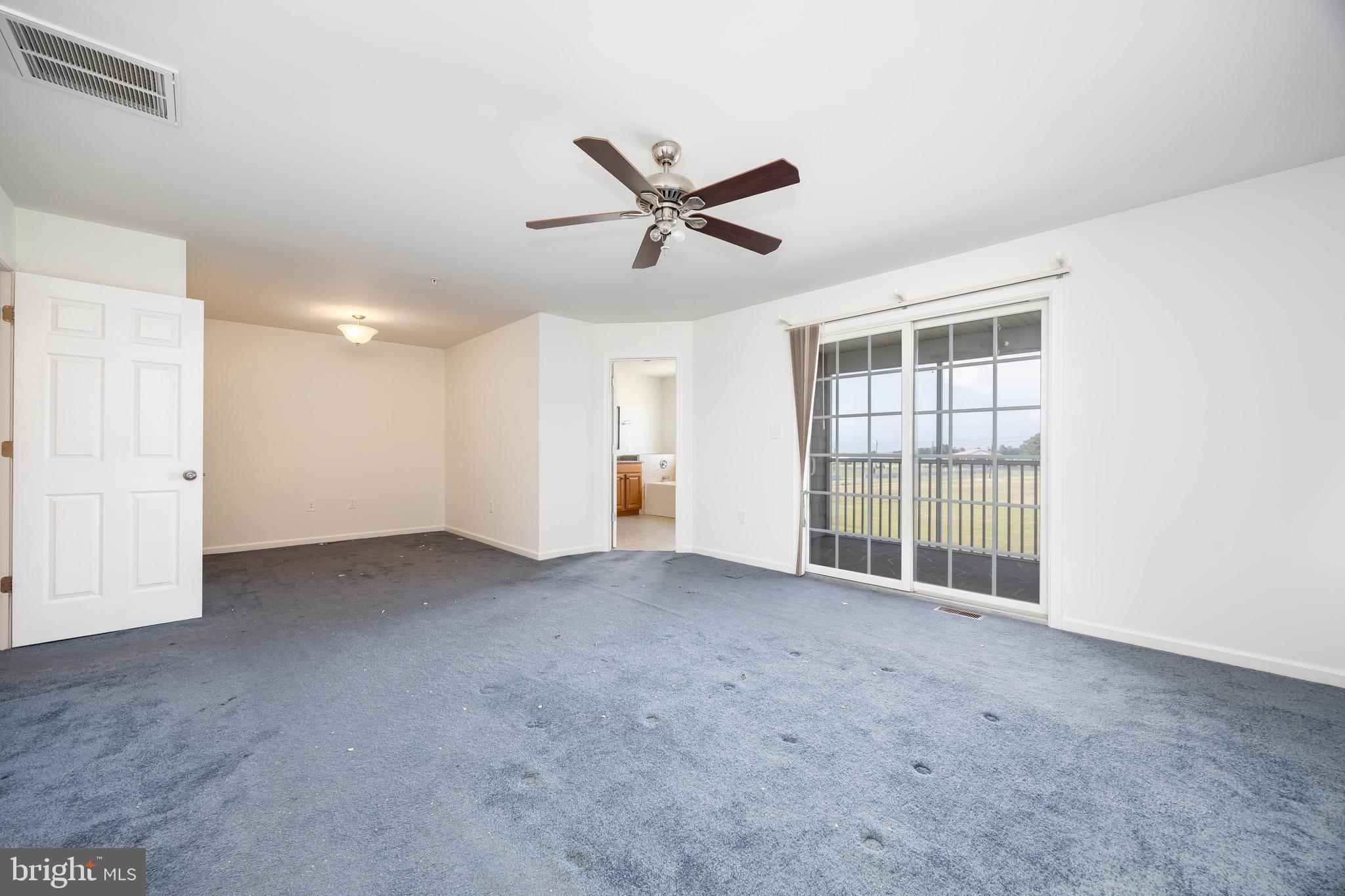 111 Sunset Circle, Unit 111E Crisfield, MD 21817 - Photo 42 of 57 a view of a livingroom with a ceiling fan and window