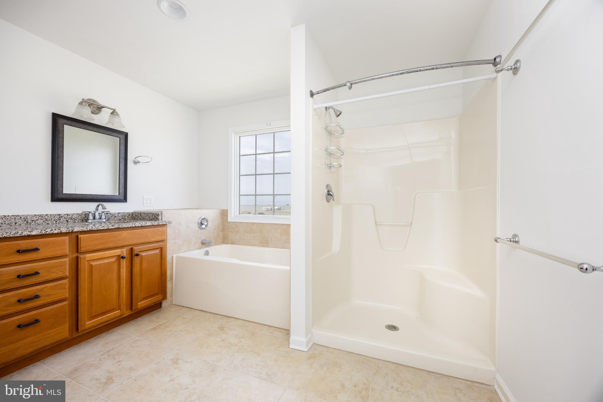 111 Sunset Circle, Unit 111E Crisfield, MD 21817 - Photo 49 of 57 a bathroom with a tub sink and mirror