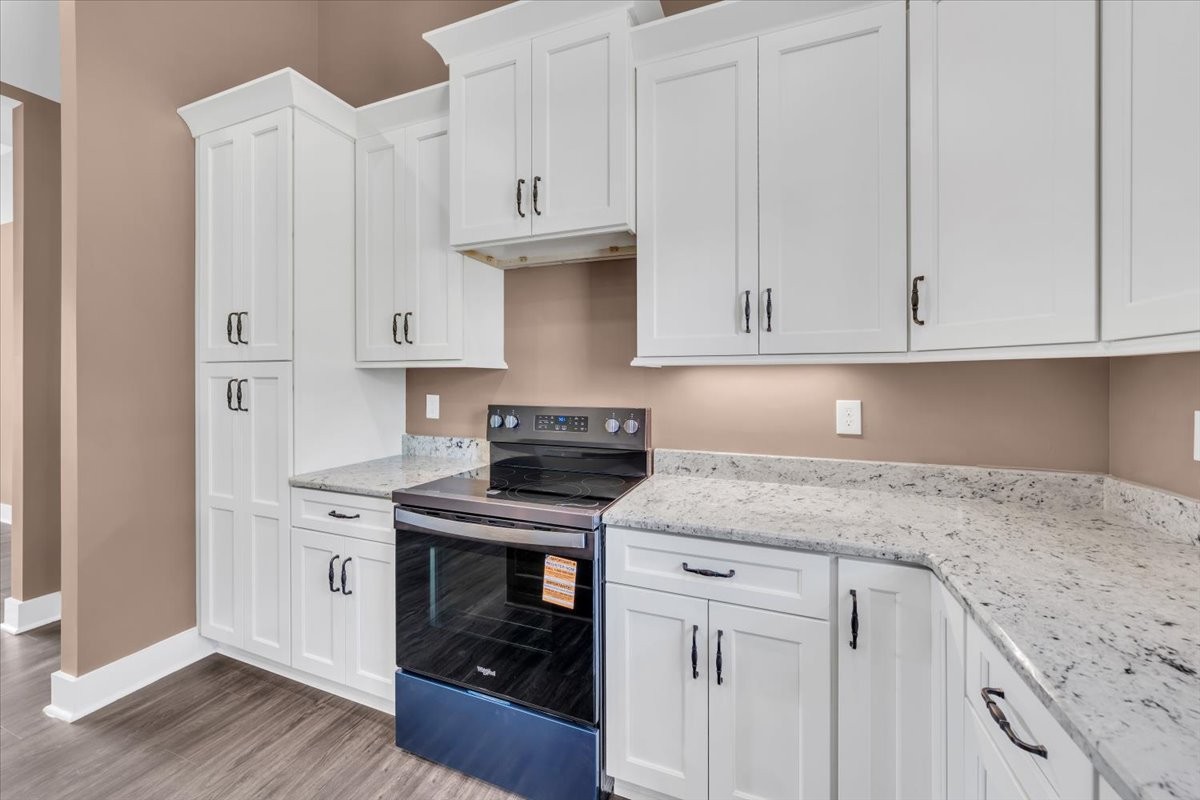 71 Brinkley Road Wartrace, TN 37183 - Photo 11 of 42 a kitchen with granite countertop white cabinets and a stove