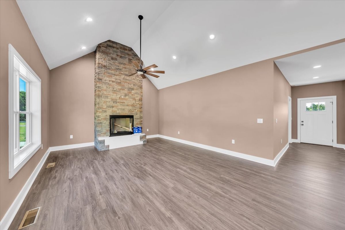 71 Brinkley Road Wartrace, TN 37183 - Photo 2 of 42 an empty room with wooden floor fireplace and windows