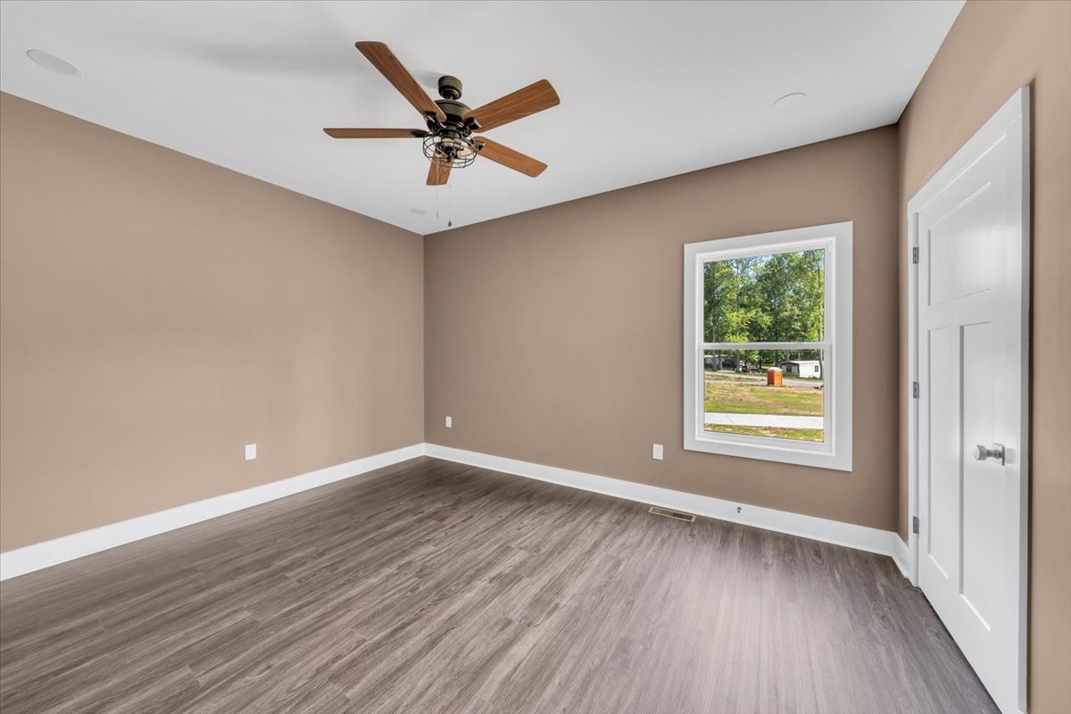 71 Brinkley Road Wartrace, TN 37183 - Photo 26 of 42 an empty room with wooden floor fan and windows