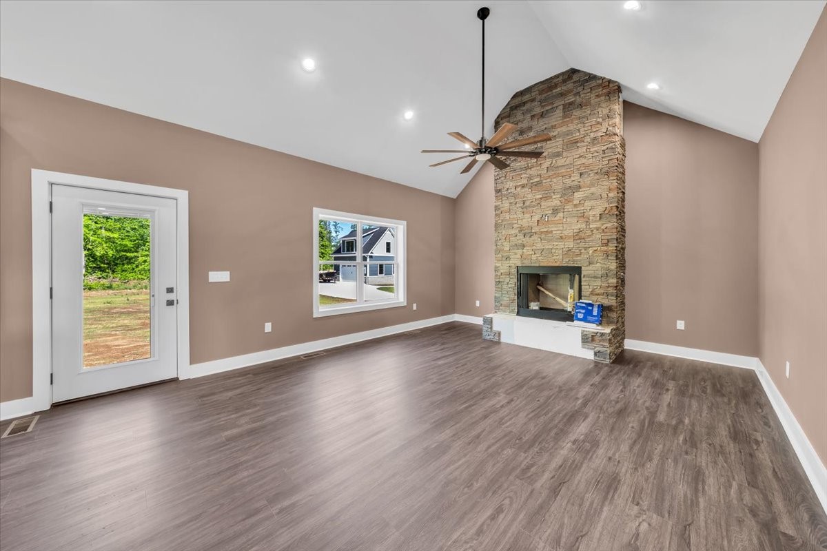 71 Brinkley Road Wartrace, TN 37183 - Photo 3 of 42 an empty room with wooden floor fireplace and windows