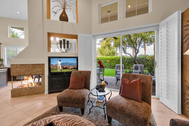 a living room with furniture and a floor to ceiling window