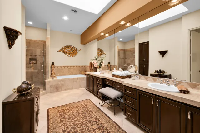 a spacious bathroom with a sink a mirror and a shower