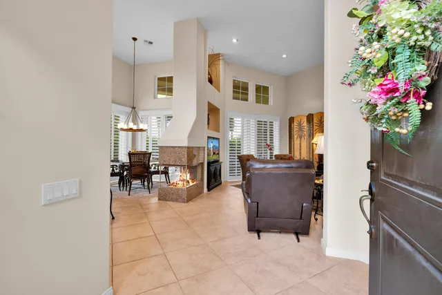 a living room with furniture and flowers