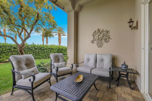 a outdoor living room with furniture and a rug
