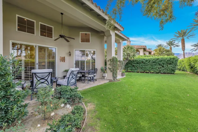 a view of a house with backyard porch and sitting area