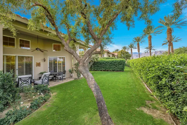 a view of a house with backyard sitting area and garden