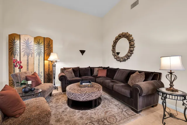 a living room with furniture and a lamp