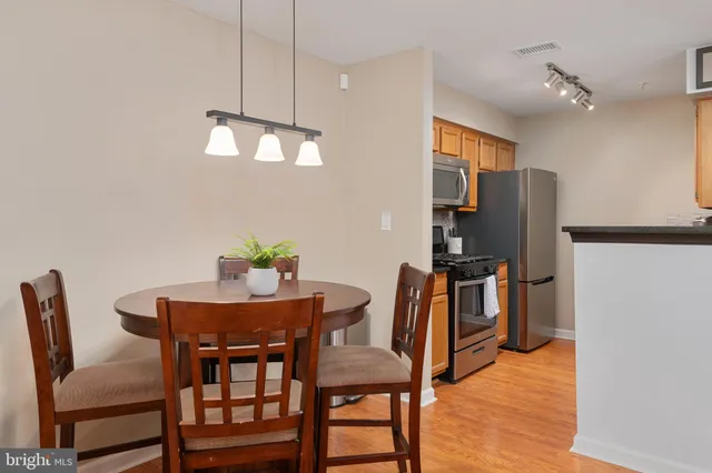 a view of a dining room with furniture and a chandelier