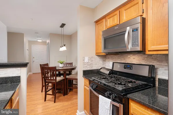 a kitchen with a stove a sink and a microwave