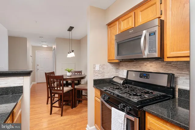 a kitchen with a stove a sink and a microwave