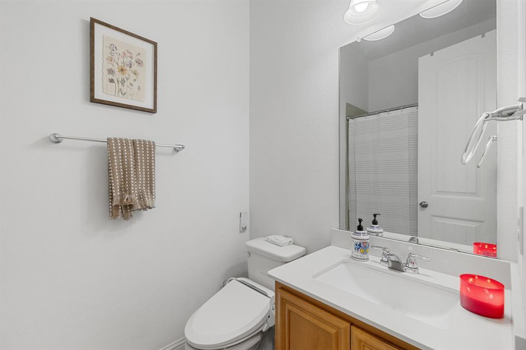 5504 Ripasso Street McKinney, TX 75070 - Photo 16 of 40 a bathroom with a sink vanity mirror and toilet