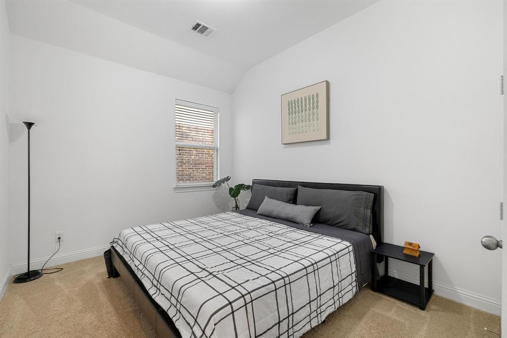 5504 Ripasso Street McKinney, TX 75070 - Photo 17 of 40 a bedroom with a bed and a night stand