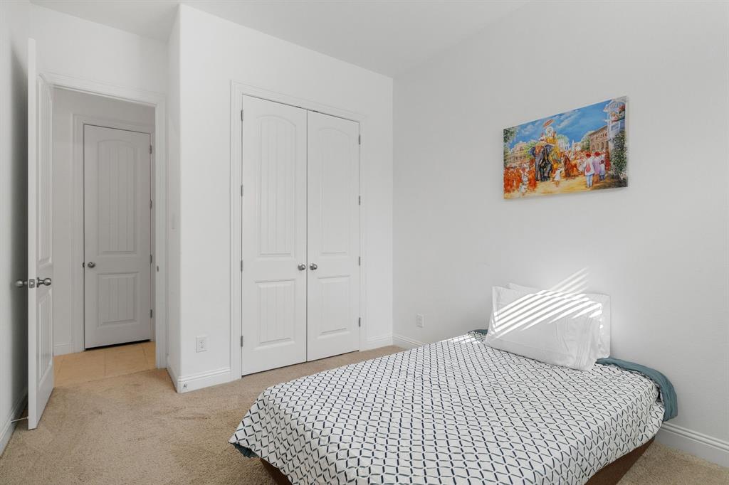 5504 Ripasso Street McKinney, TX 75070 - Photo 21 of 40 a bedroom with a bed and painting on the wall