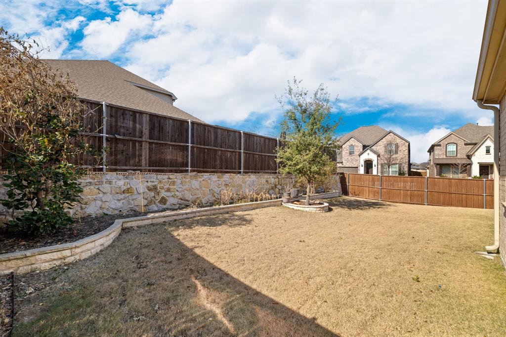 5504 Ripasso Street McKinney, TX 75070 - Photo 33 of 40 a view of large house with a yard