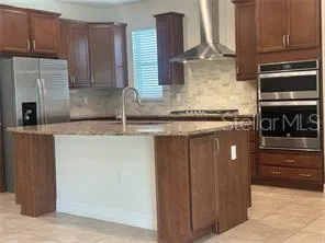 a kitchen with stainless steel appliances wooden cabinets and a counter top space
