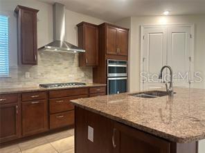 7845 Wandering Way Orlando, FL 32836 - Photo 15 of 61 a kitchen with granite countertop a sink and cabinets