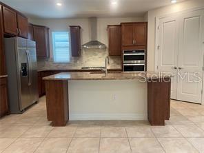 7845 Wandering Way Orlando, FL 32836 - Photo 17 of 61 a kitchen with stainless steel appliances granite countertop a refrigerator and a stove