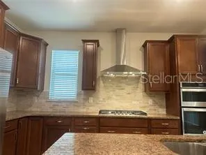 a bathroom with a double vanity sink toilet mirror and shower