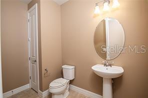 7845 Wandering Way Orlando, FL 32836 - Photo 26 of 61 a bathroom with a sink a mirror and a toilet