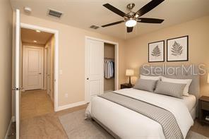 7845 Wandering Way Orlando, FL 32836 - Photo 34 of 61 a bedroom with a bed and a ceiling fan