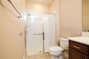 7845 Wandering Way Orlando, FL 32836 - Photo 35 of 61 a bathroom with a granite countertop sink toilet and shower