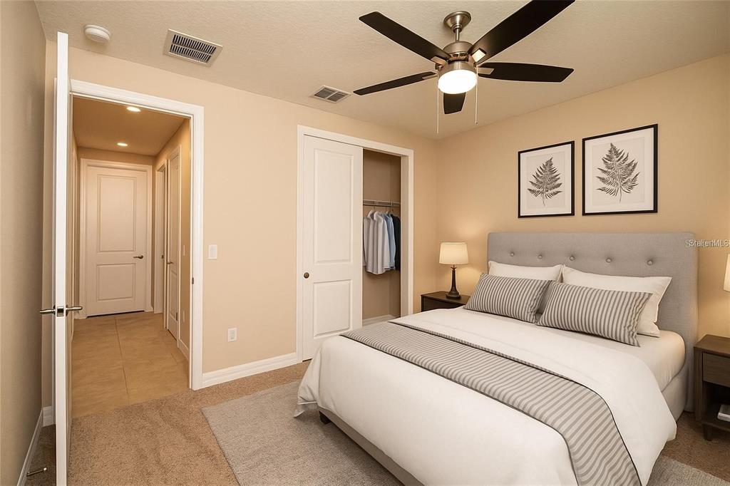7845 Wandering Way Orlando, FL 32836 - Photo 55 of 61 a bedroom with a bed and a ceiling fan