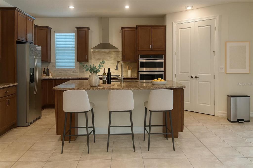 7845 Wandering Way Orlando, FL 32836 - Photo 60 of 61 a kitchen with stainless steel appliances a dining table chairs refrigerator and sink