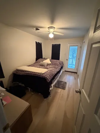 a bedroom with a bed and a mirror