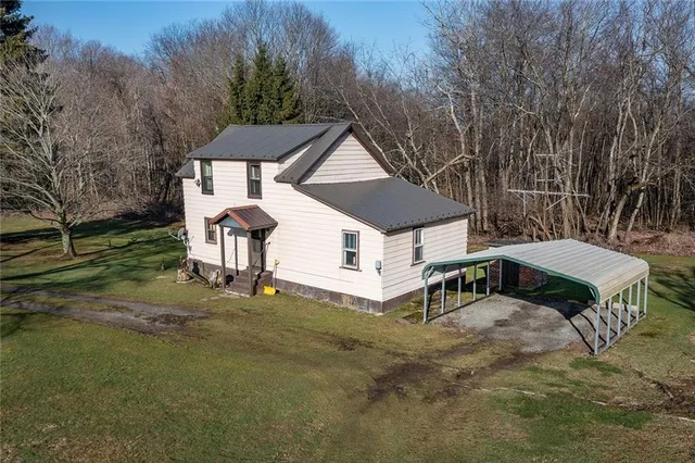 a roof view with a small yard plants and large trees
