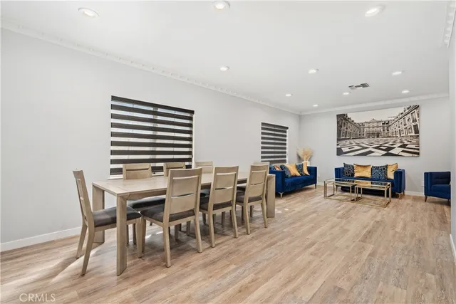 a view of a dining room with furniture and wooden floor