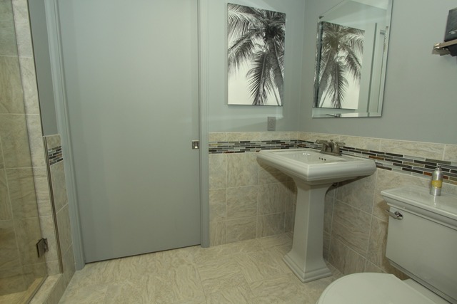 17W360 White Pine Road Addison, IL 60101 - Photo 22 of 25 a bathroom with a sink and mirror with toilet
