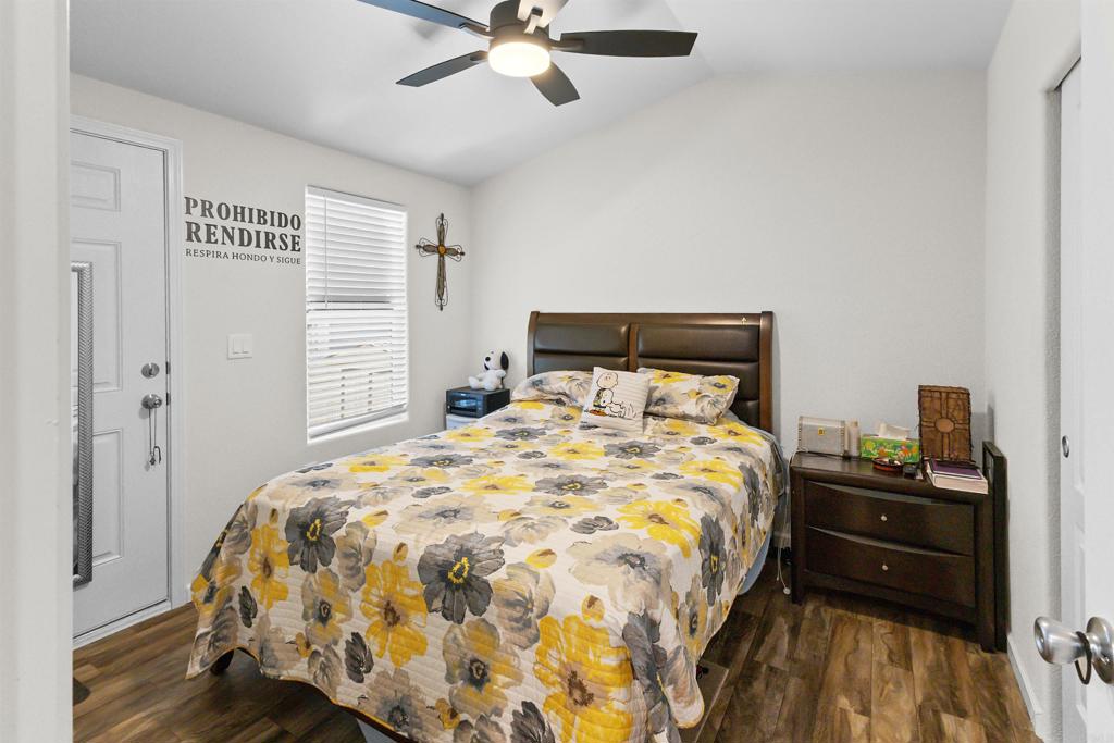 3221 Bancroft Drive, Unit 25 Spring Valley, CA 91977 - Photo 11 of 17 a bedroom with a bed and a chandelier