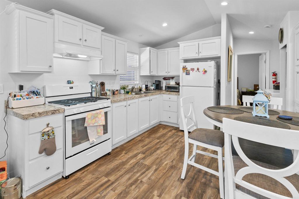 3221 Bancroft Drive, Unit 25 Spring Valley, CA 91977 - Photo 4 of 17 a kitchen with white cabinets and white appliances