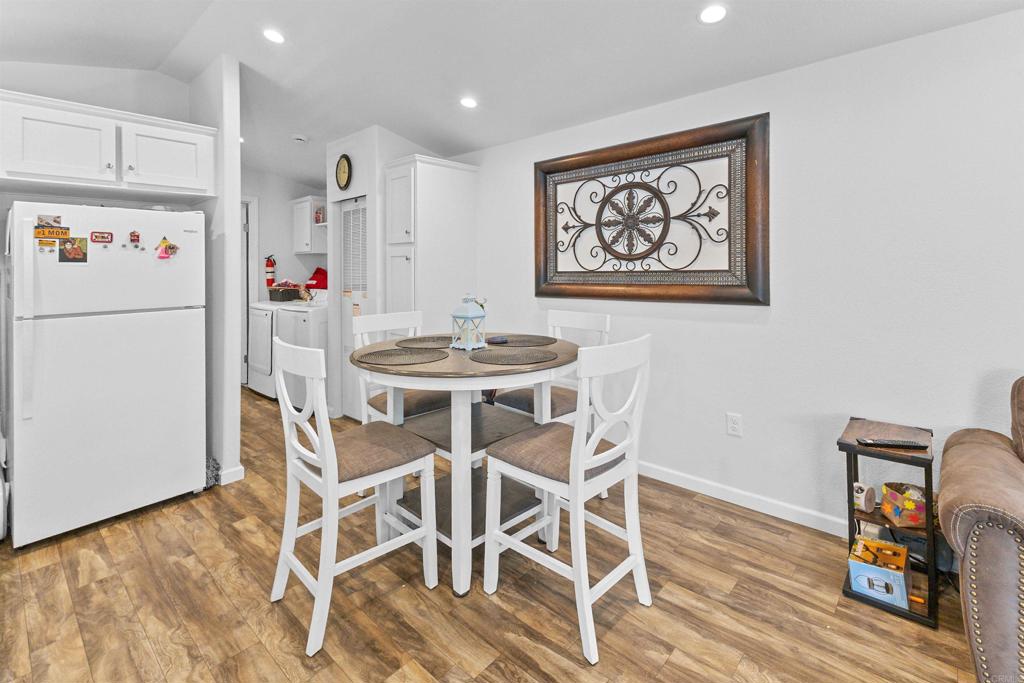 3221 Bancroft Drive, Unit 25 Spring Valley, CA 91977 - Photo 5 of 17 a view of a dining room with furniture wooden floor and kitchen view