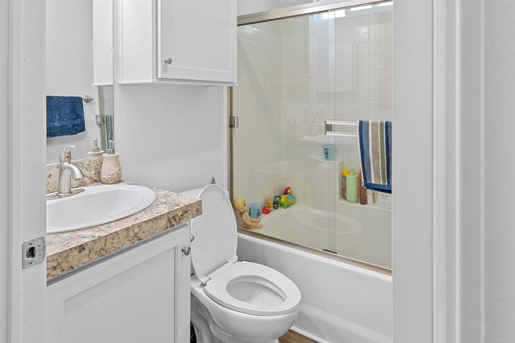 3221 Bancroft Drive, Unit 25 Spring Valley, CA 91977 - Photo 8 of 17 a bathroom with a granite countertop sink toilet and mirror